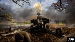 FILE - Ukrainian artillerymen fire a 152 mm towed gun-howitzer (D20) at a position on the front line near the town of Bakhmut, in eastern Ukraine's Donetsk region, on October 31, 2022, amid Russian invasion of Ukraine.