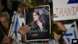 FILE - Women protest the death of Mahsa Amini, who died while being held by the morality police in Iran, during a rally in Israel, Oct. 29, 2022. The U.N. announced May 2, 2023, that its premiere press freedom prize has been awarded to three imprisoned Iranian women journalists.