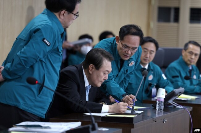 This handout photo taken and released on November 2, 2022 by the South Korean Presidential Office via Yonhap news agency shows South Korean President Yoon Suk-yeol (C) speaking at a meeting of the National Security Council over North Korea's missile launch, at the presidential office in Seoul.