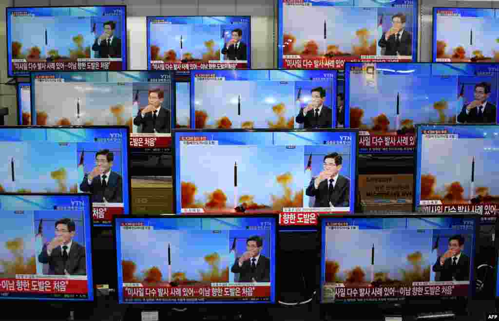 Television screens show a news report about the latest North Korean missile launch with file footage of a North Korean missile test, at an electronic market in Seoul.