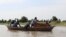 FILE: Mourners adjust a a casket on a pirogue while transporting it across floodwater to the Tukra cemetery in N'Djamena on October 29, 2022. - Chad is struggling to deal with exceptional flooding that has affected hundreds of thousands of lives.