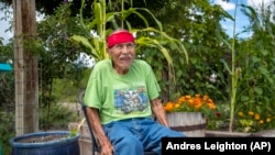 Raymond Naranjo, 99, sits outside his home in Santa Clara Pueblo in northern New Mexico, Monday, Aug. 22, 2022.