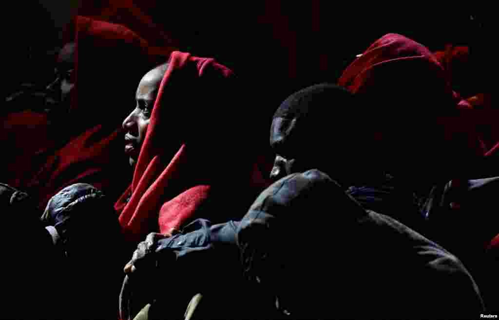 Migrants wait to disembark from a Spanish coast guard vessel, in the port of Arguineguin, in the island of Gran Canaria, Spain.