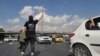 FILE - This UGC image posted on Twitter on Nov. 3, 2022, shows a person, wearing a shirt that translates from Persian to "We will fight, we will die, we will take back Iran," in the middle of a busy highway in the city of Karaj, Iran, near Tehran. 