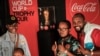 FILE - People pose for photos in front of the FIFA World Cup Trophy during the trophy tour ahead of the men's World Cup 2022 in Qatar at the Kenyatta International Convention Centre (KICC) in Nairobi, on May 27, 2022.