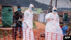 FILE - Doctors work inside an isolation center with suspected Ebola patients in Mubende, Uganda, Oct. 27, 2022.