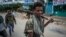 FILE - Fighters loyal to the Tigray People's Liberation Front walk in a town in the Tigray region of northern Ethiopia, May 7, 2021. TPLF fighters say they have taken control of the strategic town of Dessie in Ethiopia's Amhara region.