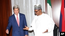 In this photo released by the Nigeria State House, U.S. Secretary of State John Kerry, left, talks to Nigeria's President Muhammadu Buhari, before their bilateral talks at the State House in Abuja, Nigeria, Tuesday Aug. 23, 2016.