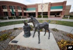 FILE - A sculpture stands outside the front door of the veterinary school at Colorado State University in Fort Collins, Colo., Nov. 6, 2017.