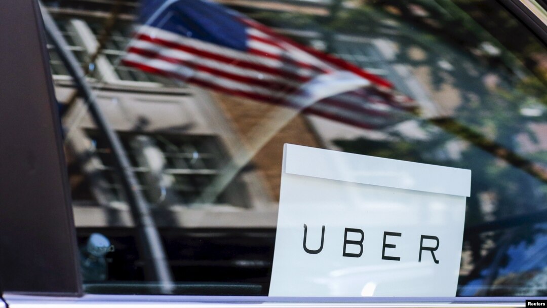FILE - An Uber sign is seen in a car in New York.