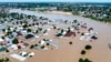 FILE - Houses and other buildings are partially submerged following a dam collapse in Maiduguri, Borno state, Nigeria, on Sept 10, 2024. Health officials say flooding has created ideal conditions for the spread of cholera.