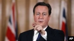 Britain's Prime Minister David Cameron gestures during a press conference in Downing Street in London, where he said aid worker Linda Norgrove, 36, who died in Afghanistan during a rescue attempt, may have been killed by her American rescuers, rather than