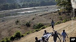 Michelet Compere, 14, suffering from cholera, is carried on a stretcher by relatives during their four-hour journey from a remote village in Pond Chevalier to the hospital in Grande Riu Du Nord village, Haiti, Nov 29, 2010