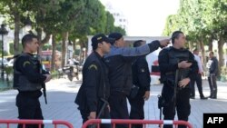 FILE - Tunisian police gathering at the site of a suicide attack in the centre of Tunis, Oct. 29, 2018.