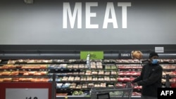 A man shops in the meat section at a grocery store in Washington, D.C., April 28, 2020.