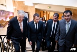 FILE - (LtoR) Vice President of the French Council of the Muslim Faith (CFCM) Chems-Eddine Hafiz, French President Macron, CFCM President Anouar Kbibech and CFM Vice President Ahmet Ogras, arrive to attend a dinner organized by CFCM, June 20, 2017.