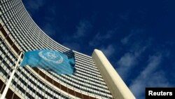 FILE - The flag of the International Atomic Energy Agency (IAEA) flies in front of its headquarters. 