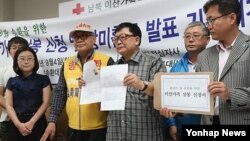 Pro-European Union activists hold lights as they sing the Ukrainian national anthem, celebrating the New Year in Kyiv, Ukraine, Jan. 1, 2014. 