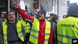 Police officers shout slogans as they protest against their pension fund's participation in the Greek bond swap in Athens March 7, 2012.