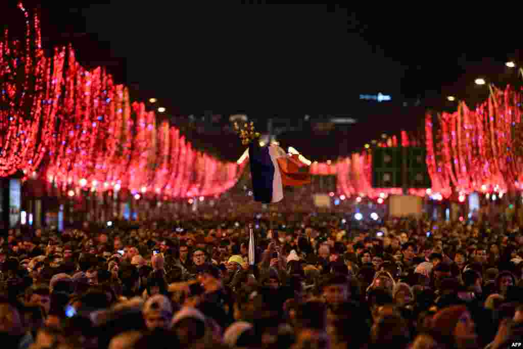 People gather in the Champs-Elysees as the French capital Paris gears up for New Year&#39;s Celebrations, Dec. 31, 2018.