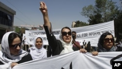 An Afghan protestor shouts slogans during a demonstration in support of female victims of abuse and violence in Kabul, Afghanistan, July 11, 2012.