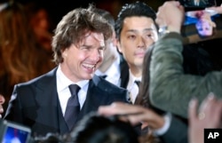 FILE - Actor Tom Cruise smiles at fans upon his arrival for the Japan premiere of "Jack Reacher: Never Go Back" in Tokyo, Nov. 9, 2016. Cruise stars in a new movie, "The Mummy," that debuted Wednesday at CinemaCon in Las Vegas.