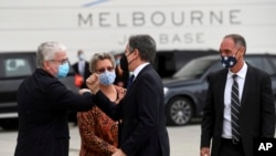 United States' Secretary of State Antony Blinken, second right, is met by United States' Charge 'dAffaires to Australia Michael Goldman, right, and Australia's Department of Foreign Affairs and Trade first Assistant Secretary Craig Chittick, left, after a