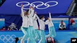 Gold medalists from the Russian team celebrates following the victory ceremony after the team event in the figure skating competition at the 2022 Winter Olympics, Feb. 7, 2022, in Beijing. 