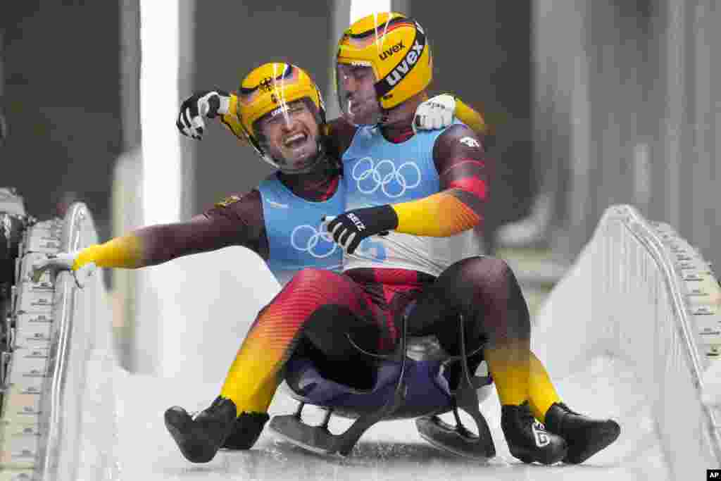 Tobias Wendl and Tobias Arlt of Germany celebrate winning the gold medal in luge doubles at the 2022 Winter Olympics, Feb. 9, 2022, in the Yanqing district of Beijing.