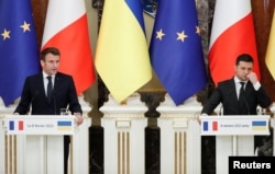 FILE - Ukrainian President Volodymyr Zelenskiy and French President Emmanuel Macron attend a news briefing following their talks in Kyiv, Ukraine, Feb. 8, 2022.