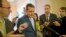 Senator Ted Cruz is pursued by reporters upon his return to Capitol Hill in Washington, Oct. 11, 2013.