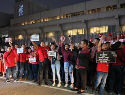 FILE - Employees of broadcaster ABS-CBN protest in front its building in Manila, Feb. 14, 2020. Government lawyers moved this year to strip the broadcast group of its operating franchise in what many saw as an attack on press freedom.