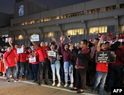 FILE - Employees of broadcaster ABS-CBN protest in front of the ABS-CBN building in Manila, Feb. 14, 2020. Government lawyers moved this year to strip the broadcast group of its operating franchise, in what many saw as an attack on press freedom.