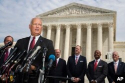 FILE - Nebraska Attorney General Doug Peterson with a bipartisan group of state attorneys general speaks to reporters in front of the U.S. Supreme Court in Washington, Sept. 9, 2019.