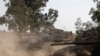 Israeli tanks manoeuvre near the Israel-Gaza border