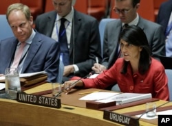 FILE - United Kingdom U.N. Ambassador Matthew Rycroft, left, listens as United States U.N. Ambassador Nikki Haley, right, respond to Russia's statements, during United Nations Security Council meeting on North Korea's latest launch of an intercontinental ballistic missile, July 5, 2017, at U.N. headquarters.