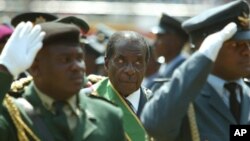 FILE - Zimbabwean President Robert Mugabe (C), surrounded by members of the military, is seen attending 25th anniversary Independence celebrations in Harare, Zimbabwe, April 18, 2005.