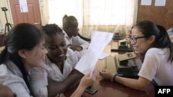 FILE - Chinese language teachers talk to a Nigerian student at the Confucius Institute at the University of Lagos, April 6, 2016. Confucius Institutes in the United States are rebranding and reopening, according to a report by the National Association of Scholars.