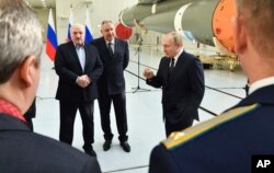 Russian President Vladimir Putin, right, Belarusian President Alexander Lukashenko, left, and Russian Roscosmos head Dmitry Rogozin visit the Vostochny cosmodrome outside the city of Tsiolkovsky, about 200 kilometers (125 miles) from the city of Blagovesh