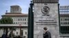 A man phones with his mobile while entering the World Trade Organization (WTO) headquarters in Geneva, Apr. 12, 2022. 