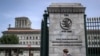 FILE - A man phones with his mobile while entering the World Trade Organization (WTO) headquarters in Geneva, Apr. 12, 2022. 