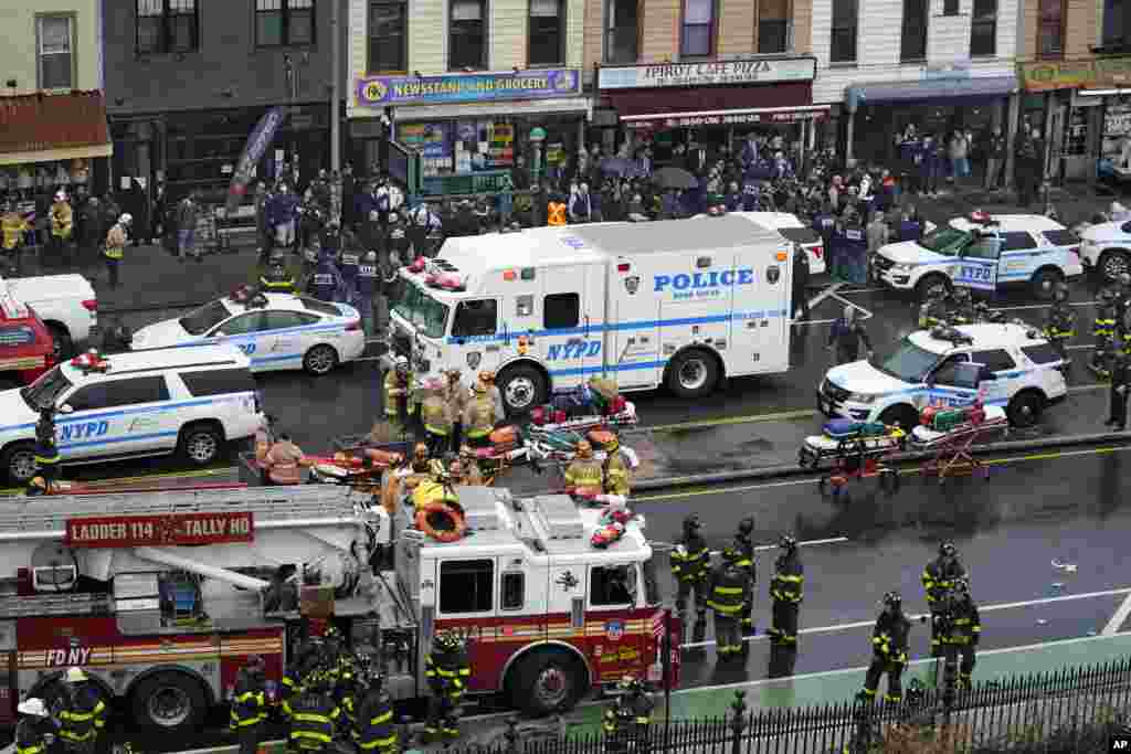 Emergency workers gather at the entrance to a subway station in the Brooklyn area of New York. Several people were shot and injured at the subway station during a morning attack.