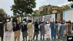 Afghans chant slogans against Iran during a demonstration in Kabul, Afghanistan, April 12, 2022. 