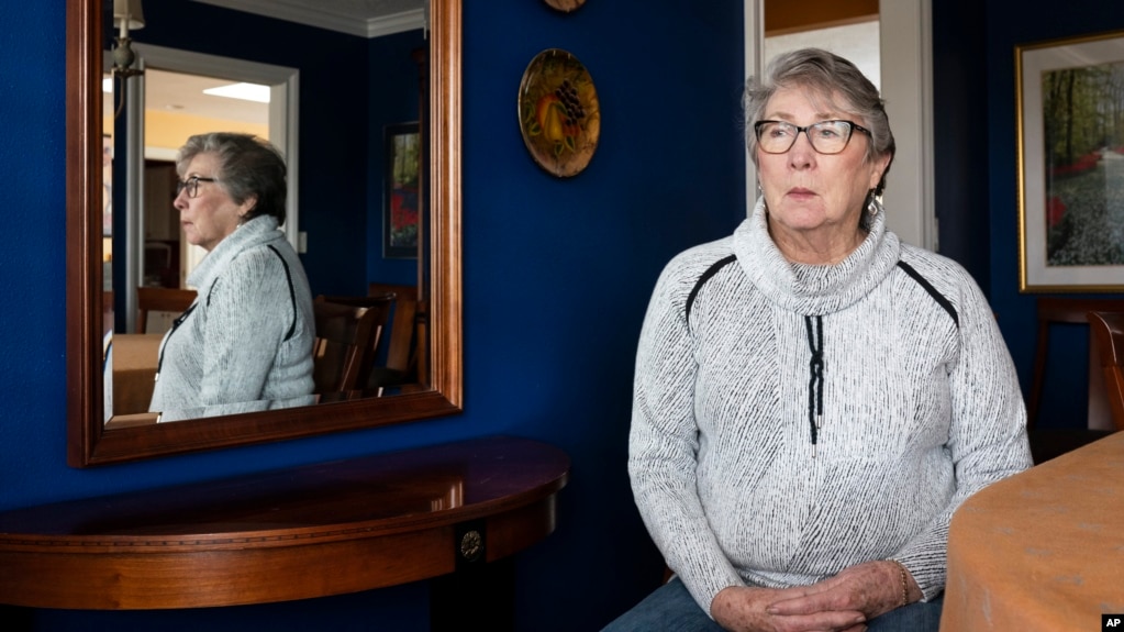 Joyce Ares sits for a portrait in the dinning room of her home on Friday, March 18, 2022, in Canby, Ore. (AP Photo/Nathan Howard)