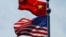 FILE - Chinese and U.S. flags flutter near The Bund in Shanghai, China July 30, 2019. 