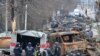 Los ingenieros de campo del Servicio Estatal de Emergencia de Ucrania realizan la limpieza de minas entre los vehículos destruidos en una calle de Bucha el 5 de abril de 2022, mientras las autoridades ucranianas dicen que se han recuperado más de 400 cuerpos civiles de la región más amplia de Kiev, muchos de los cuales fueron enterrados en tumbas.