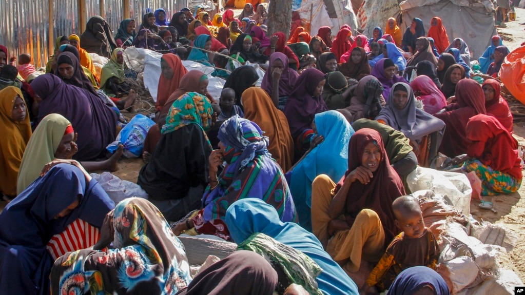 FILE - Somalis who fled drought-stricken areas sit at a makeshift camp on the outskirts of the capital Mogadishu, Somalia on Feb. 4, 2022. (AP Photo/Farah Abdi Warsameh, File)