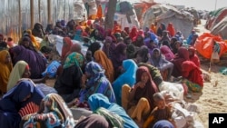 Somalis who fled drought-stricken areas sit at a makeshift camp on the outskirts of the capital Mogadishu, Somalia, Feb. 4, 2022.