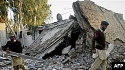 Pakistani soldiers walk through the rubble of a damaged building at the site of suicide bombing in Ghalanai, the main town in Pakistani tribal area Mohmand, Dec. 6, 2010