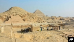This photo provided by the Saqqara Saite Tombs Project in January 2023 shows an excavation area overlooking the pyramid of Unas and the step pyramid of Djoser in Saqqara, Egypt.